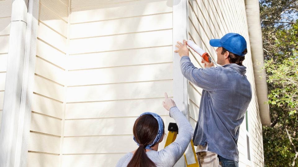 maintenance workers fixing exterior of property