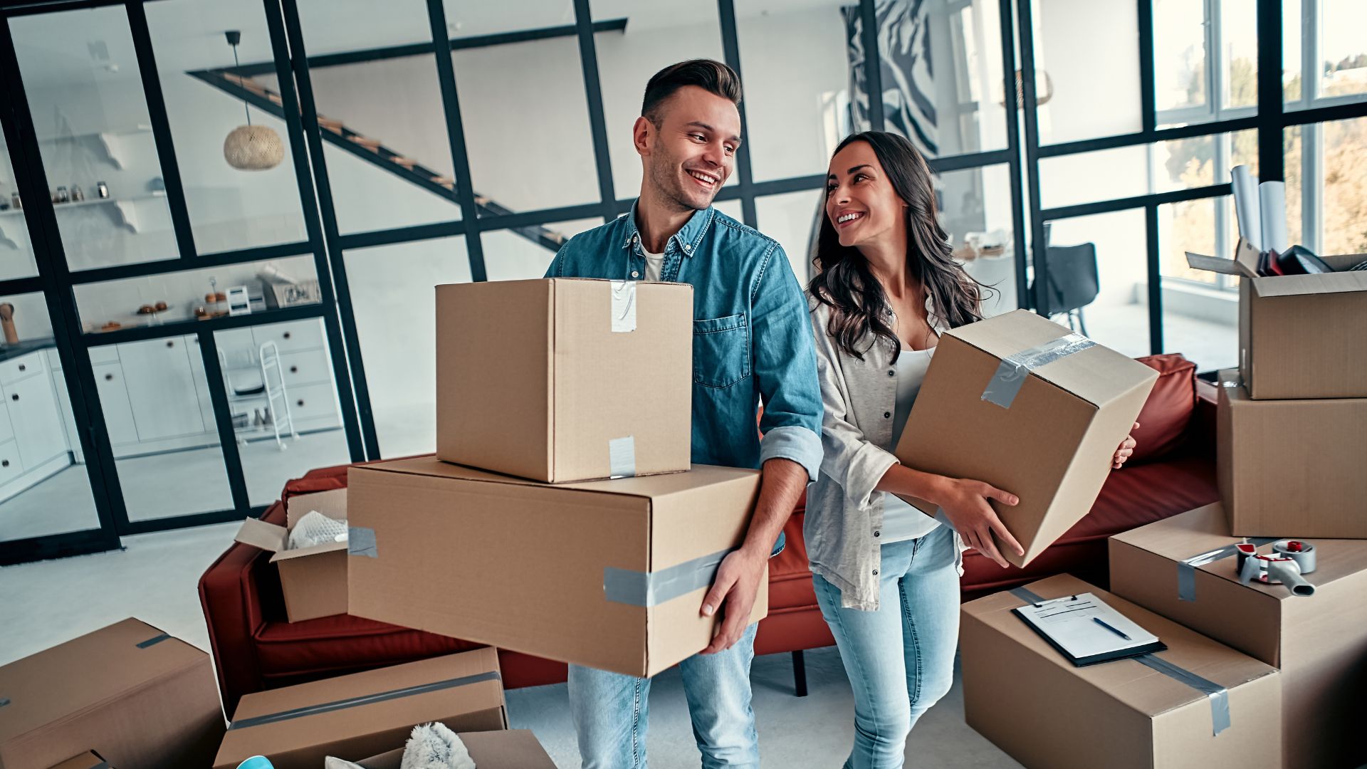 two tenants carrying moving boxes